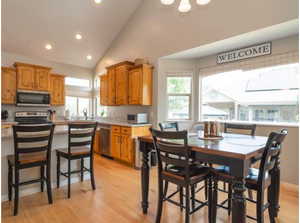 Kitchen featuring appliances with stainless steel finishes, light countertops, recessed lighting, plenty of natural light, and light wood-style flooring