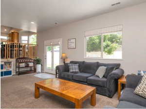 Living area with carpet flooring and recessed lighting