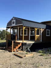View of front of home with a porch and metal roof