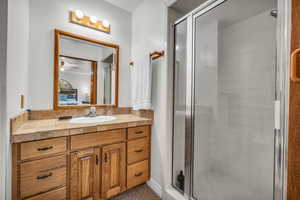 Master Bathroom with vanity, a shower stall, and ceiling fan