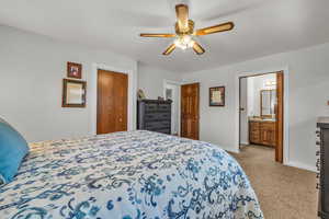 Master Bedroom 1. Carpeted bedroom with baseboards, a closet, ceiling fan, and ensuite bathroom