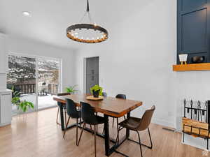 Dining space with hall to laundry room and garage door. View to backyard bliss.