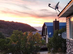 Back deck sunrise view of closest neighboring home o the East zoomed in a bit.