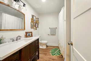 Bathroom featuring vanity and wood finished floors