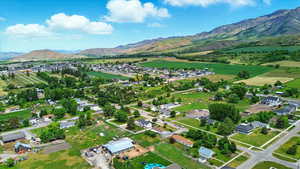 Aerial view of property's location featuring a mountainous background