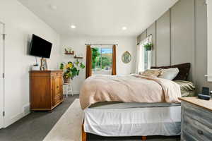 Bedroom with dark carpet and recessed lighting