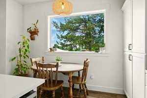 Dining space with wood finished floors and baseboards