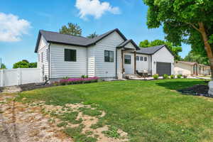View of front of house featuring an attached garage and a gate