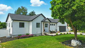 View of front of property with a garage, roof with shingles, and concrete driveway