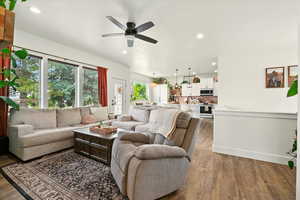 Living area with ceiling fan, wood finished floors, and recessed lighting