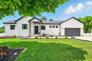 View of front of property with a garage, concrete driveway, an outdoor living space, and a shingled roof