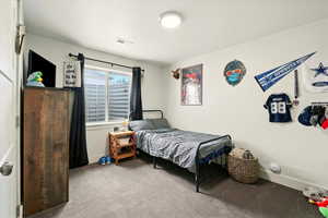 Bedroom with carpet floors and baseboards