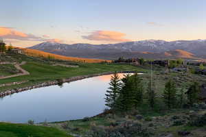 Mountain view featuring a nearby body of water and a golf club