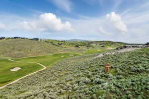 View of community with golf course view and a mountain view