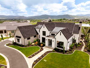 Aerial view of property and surrounding area with mountains