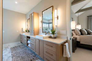 Full bathroom featuring vanity, recessed lighting, vaulted ceiling, and marble finish floors