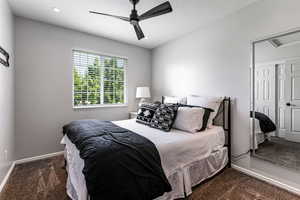 Bedroom with carpet floors, a ceiling fan, and a closet