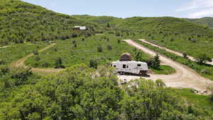 View of subject property with a forest and mountains