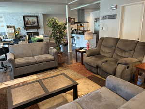 Living room featuring wood finished floors and a fireplace