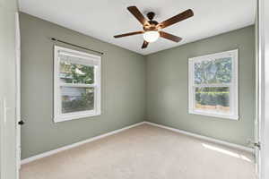 Spare room with carpet flooring and a ceiling fan