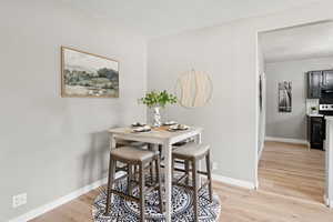 Dining space featuring light wood finished floors and baseboards