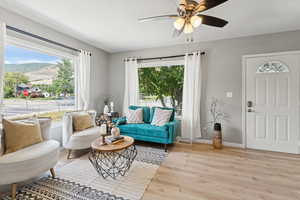 Living room with wood finished floors, healthy amount of natural light, and a mountain view