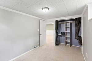 Unfurnished bedroom featuring carpet floors and crown molding