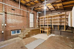 Unfinished below grade area featuring stairs