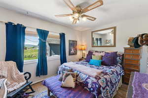 Bedroom featuring wood finished floors and ceiling fan