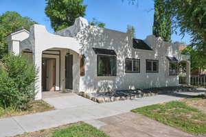 View of front of house featuring stucco siding and driveway