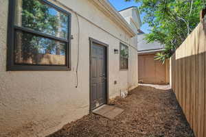 Entrance to property featuring stucco siding