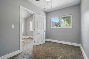 Room featuring carpet flooring and a ceiling fan