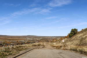 View of asphalt street featuring a mountain view and curbs