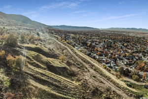 View of mountain backdrop featuring nearby suburban area