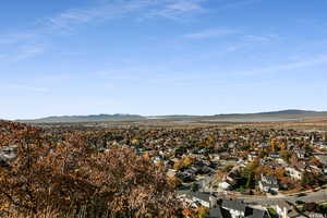 Aerial overview of property's location featuring a mountain backdrop and nearby suburban area