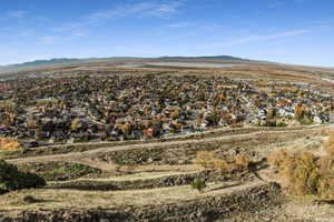 View of property location featuring nearby suburban area and a mountain backdrop