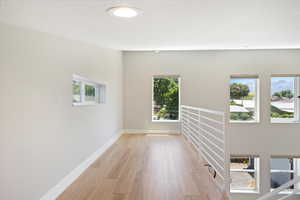 Spare room with light wood-type flooring and baseboards