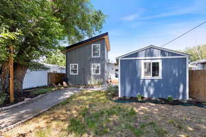 Rear view of property with an outdoor structure