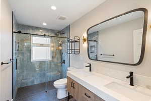 Full bathroom with double vanity, a stall shower, recessed lighting, and tile patterned floors