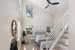 Bedroom featuring high vaulted ceiling, multiple windows, wood finished floors, recessed lighting, and ceiling fan