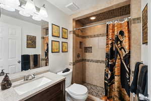Full bathroom featuring vanity and tiled shower
