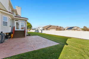 View of yard featuring a patio, a residential view, entry steps, and french doors