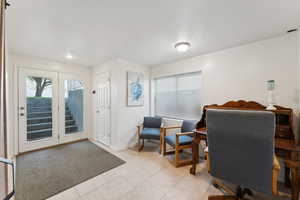 Office area with plenty of natural light and light tile patterned flooring