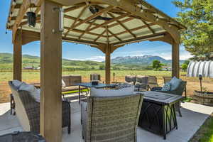 View of patio / terrace featuring outdoor lounge area, a mountain view, and a rural view