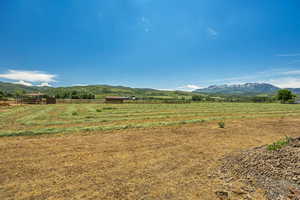 View of mountain backdrop featuring rural landscape