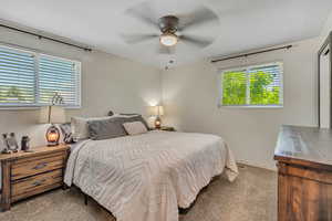 Carpeted bedroom with ceiling fan