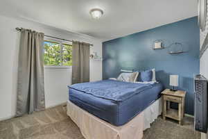 Carpeted bedroom featuring baseboards