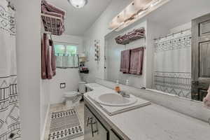 Full bathroom featuring vanity, tile patterned flooring, and a shower with shower curtain