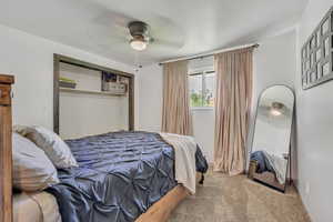 Bedroom featuring carpet flooring, a closet, and a ceiling fan