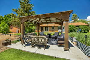 View of patio with a gazebo and outdoor lounge area